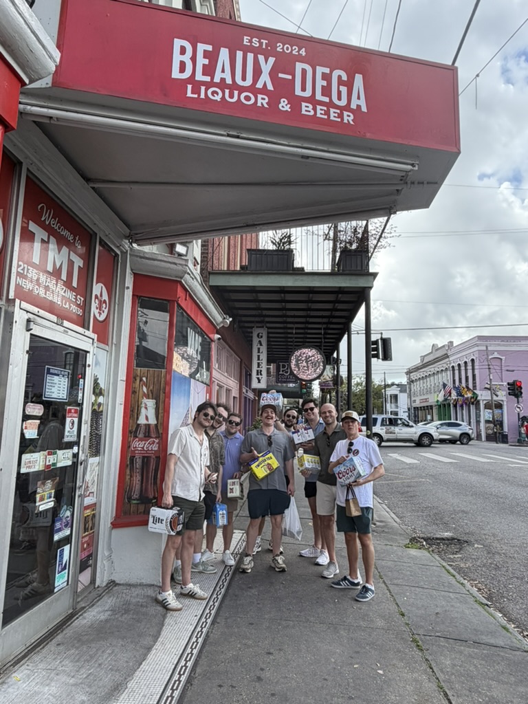 Friends outside Beaux-dega beneath its red Magazine Street awning